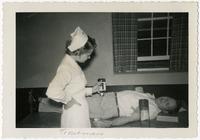 Nurse Jean Payne Rabie assisting a patient