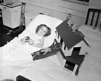 Polio patient with a dollhouse