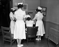 Nurses examining charts at Wesley Long Hospital