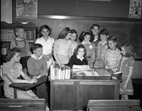 Students Gather around a Desk, Ceasar Cone School