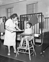 Boy being fed at polio hospital
