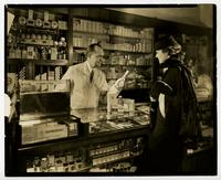 Staged photograph of Vicks being purchased at a drug store