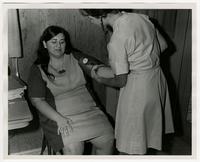 Nurse examining infant