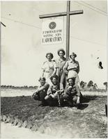 WACs in front of photographic mapping squadron sign