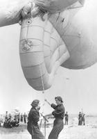 Two Royal Air Force servicewomen hold down balloon