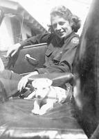 Marjorie Thompson in a car with a puppy