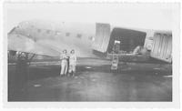Red Cross workers in front of plane
