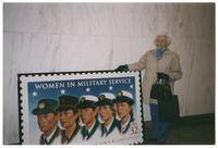 Dorothy Baker in front of Women in Military Service Stamp
