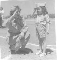 Lt. Elizabeth Ray saluting child