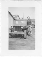 Betty Wiker by military vehicle at Camp Simms