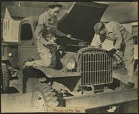 Offical United States Army Signal Corps photograph of two WAACs servicing an army truck