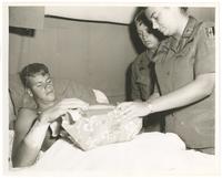 Diane Kay Corcoran delivering care package to soldier at the 24th Evacuation Hospital in Long Binh, Vietnam