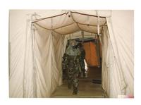 Unidentified solider walks while wearing United States Army hazmat suit