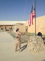 Niddie Miyo raising an American Flag