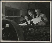 WAVES examine a newspaper by a printing press