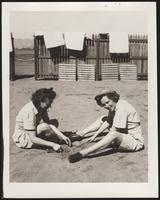 Two WACs play in sand
