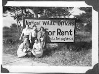 WAACs in front of sign