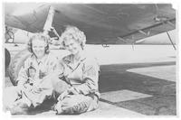 June Neely Baker and coworker under airplane