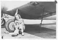 June Neely Baker beside an airplane