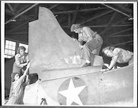 Phyllis Snyder and other Women Marines working on airplane tail repair