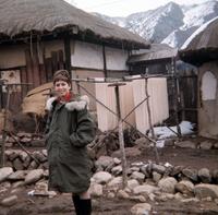 American Red Cross worker posing in front of drying noodles in South Korea